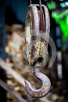 Big rusty steel hook weighs