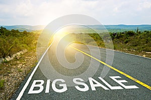 Big sale, concept photo of asphalt road. Motivational inscription on the road going forward. The beginning of a new path. A