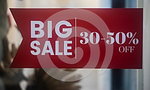 Big sale signs in shop window photo