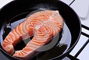 Big salmon steak roasting on pan