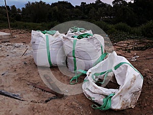 Big sand bags on construction site. A large sandbag ready for building.