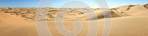 Big sand dunes panorama. Desert or beach sand textured background.