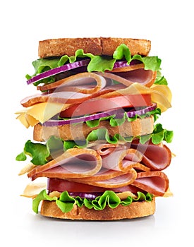 Big sandwich with ham and vegetables isolated on white background.