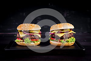 Big sandwich - hamburger burger with beef, tomato, cheese, pickled cucumber