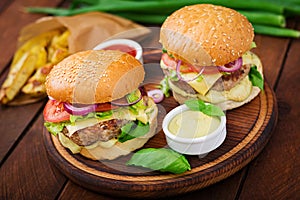 Big sandwich - hamburger with juicy beef burger, cheese, tomato, and red onion