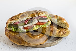 A big sandwich made with Ramadan Bread,Pide on wooden plate.