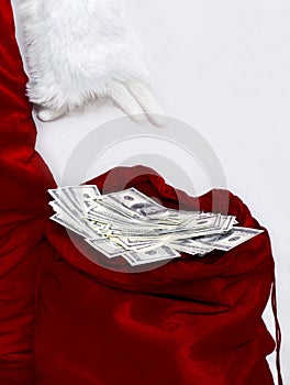 Big Santa`s bag full of dollars on white background