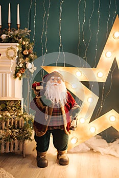 Big Santa toy in front of decorated room. Christmas mood. New Year concept