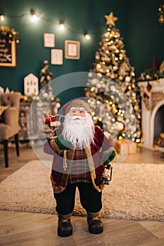 Big Santa toy in front of decorated room. Christmas mood. New Year concept