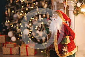 Big Santa toy in front of decorated room. Christmas mood. New Year concept