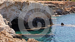 Big Sea Cave. Seascape. Travel concept. Seascape on the background of the wild rocky coast. Wild beach, azure water and rocks