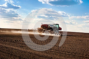 Big self-propelled sprayer in the field makes fertilizers in early spring