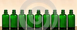 Big set of green empty bottles for herbal cosmetics