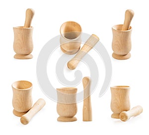 Big set of wooden mortar and pestle isolated on white