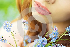 Big lips girls with blue flowers in her hands