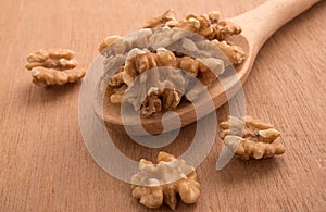 Big shelled walnuts on a wooden spoon