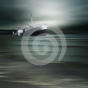 Big ship aground in stormy weather in color