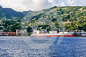 Big ship in harbor of Kingstown with the panoramic view on the island of Saint Vincent photo