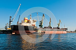 Big ship unloading in shipyard