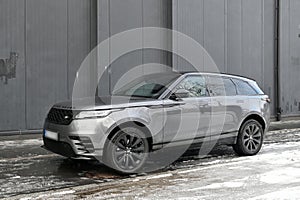 Big silver grey British 4WD compact luxury crossover car Range Rover Velar parked in ice and snow