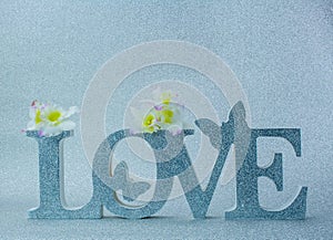 Big silver letters LOVE on silver background