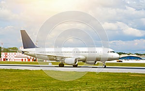 Big silver passenger jet plane on runway at airport a sunny day