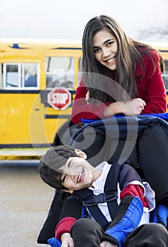 Big sister with disabled brother at school