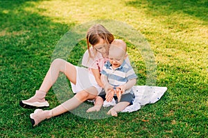 Big sister playing with adorable baby brother