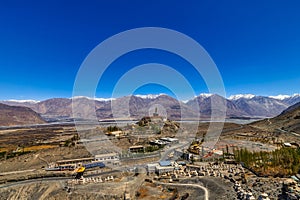 Big Sitting Buddha Statue at Diskit Monastery with Himalaya Range in the back - Nubra Valley, India.