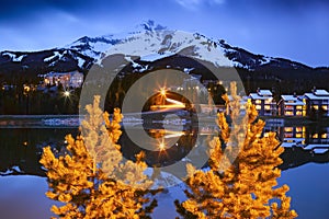 Big Sky Mountain Village on dusk, snowy Lone Mountain, Montana USA photo