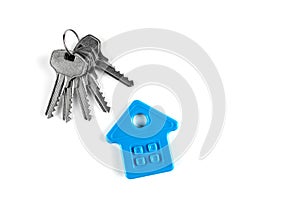 Big and small house keys. Below is the symbol of the house. Close up on a white background. There is a place to sign the copyspace