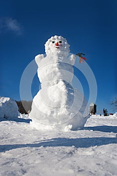 Big snowman on sky background