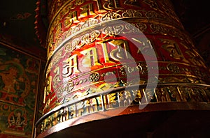 Big Spinning Tibetan Buddhist prayer wheel at Boudhanath stupa in Kathmandu