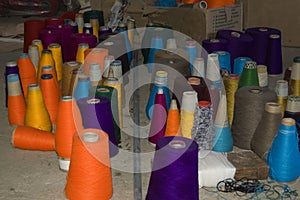 Big spools of colorful threads for weaving photo