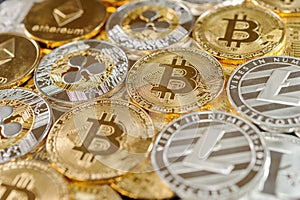 Stack of bitcoin, ripple, etherum and litecoin coins. Virtual currency concept.