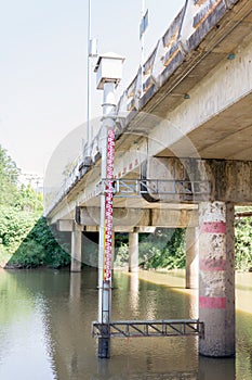 Big staff gage set up beside the bridge for water monitoring