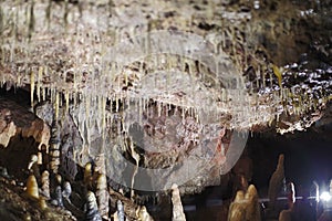 a big stalactite is hanging from the rock