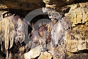 a big stalactite is hanging from the rock