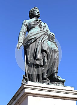 big statue of the composer Mozart with the background of the blu photo