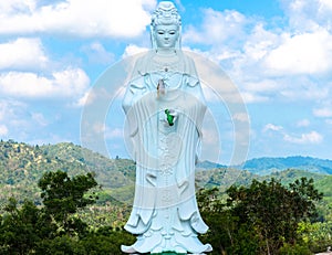 Big Statue of Guanyin on blue sky at Wat Suwan Khiri, Simmulate