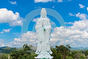 Big Statue of Guanyin on blue sky at Wat Suwan Khiri, Simmulate