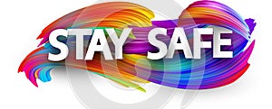 Big stay safe sign over brush strokes background