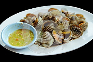 Big Steamed cockle Boiled cockles with tasty sauce in black isolated