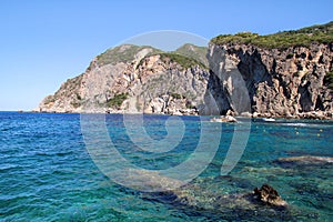 Big stone mountains and rocks coastline as islands in sea or ocean against clear sky landscape. Summer trip. Beautiful Greece.