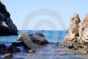 Big stone mountains and rocks coastline as islands in sea or ocean against clear sky landscape. Summer trip. Beautiful Greece.