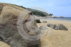 Big stone on sandy beach
