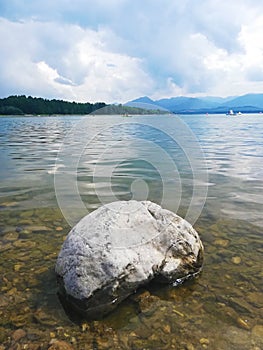 Big stone on the shore of a lake