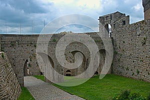 Big stone walls, gate and bridge at Dinan fortress, France