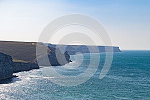 Big stones calm sea, clear sky with clouds skyline and infinity