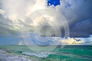 Big storm clouds in sky above blue sea